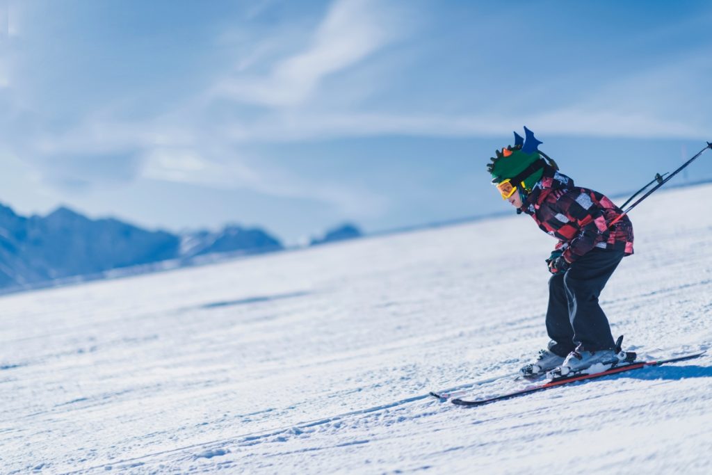Child skiing in the mountains at Livigno, Italy. Image Microgen Shutterstock