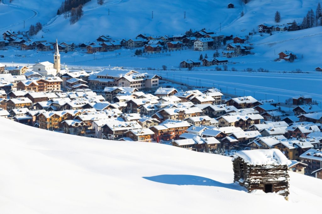 Livigno village illuminated by sun after a snowfall, Valtellina, Lombardy, Italy. Image Robert Harding Video Shutterstock