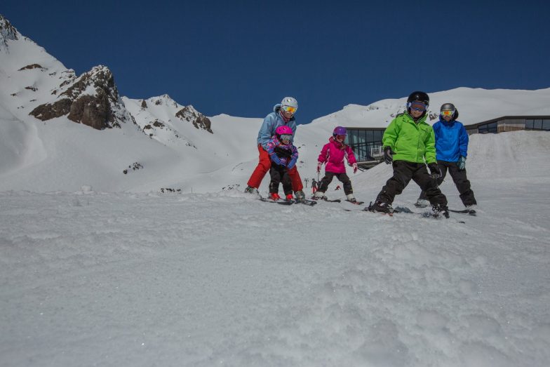 Skiing at Whakapapa New Zealands largest ski area with Knoll Ridge Cafe in background