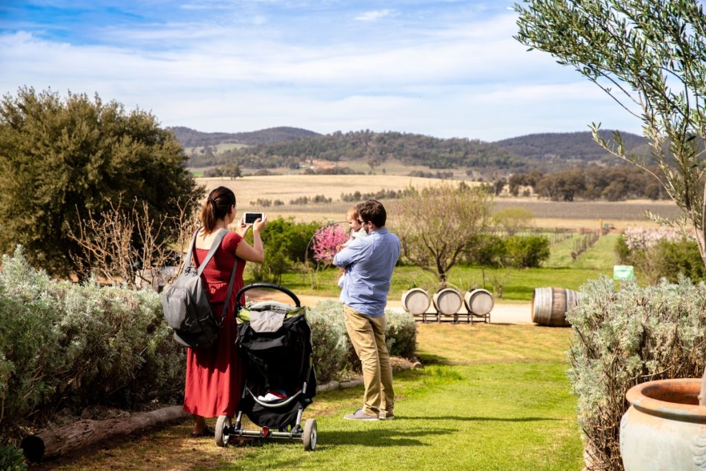Family enjoying a walk through the scenic grounds at Lowe Wines, Mudgee. Image Destination NSW