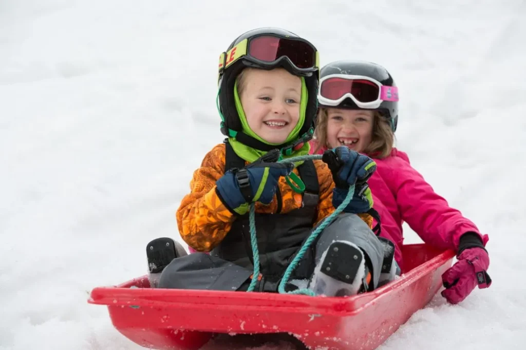 Two children sledding in Happy Valley 1 e1638388939448