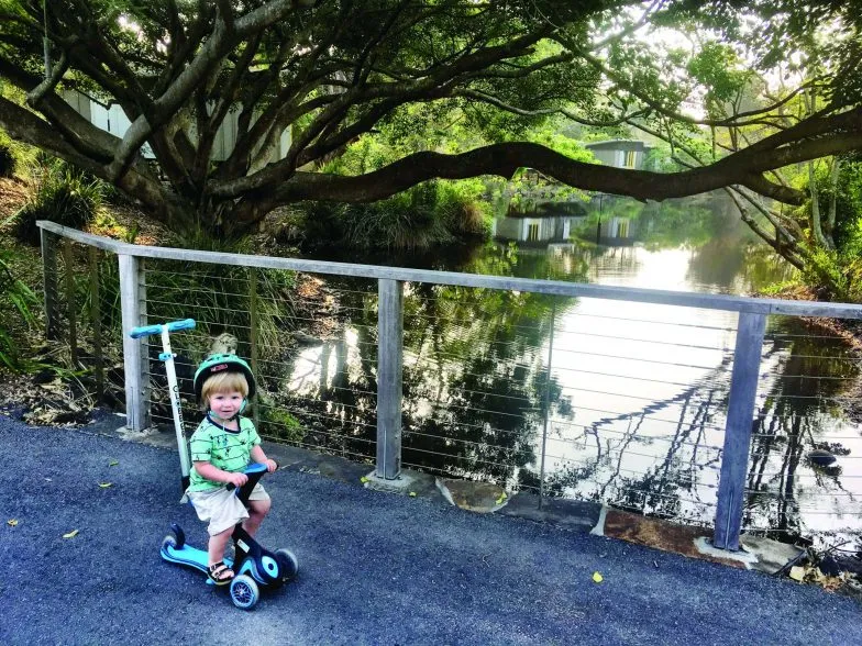 Oliver on his scooter at Elements of Byron Resort and Spa scaled e1638296693611