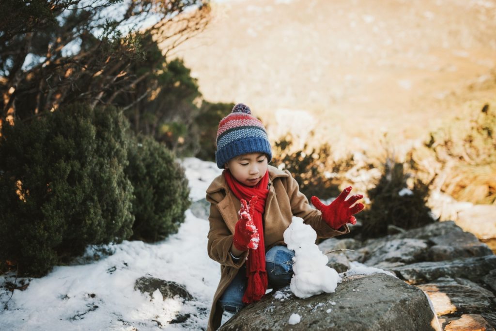 Child playing in the snow at Cradle Mountain. Image Laura Helle Tourism Tasmania