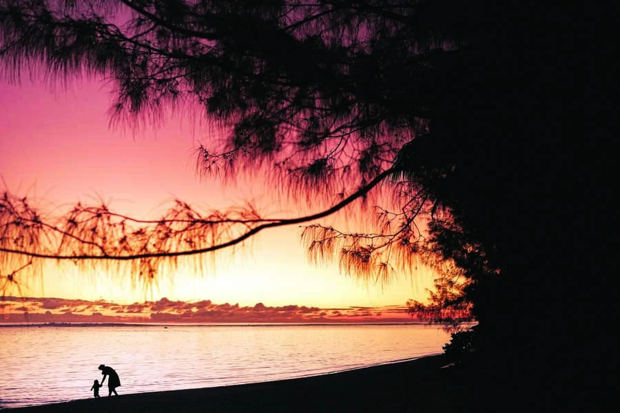 sunset on the beach in front of the rarotongan. image chris van hove