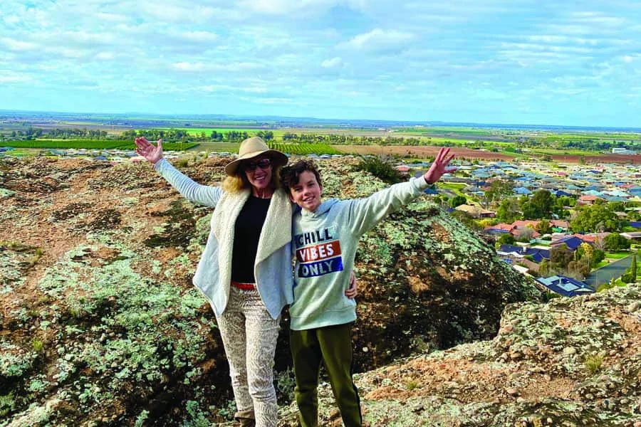 katrina and remy enjoying panoramic riverina valley views from the clifftop plateau of the hermits cave griffith