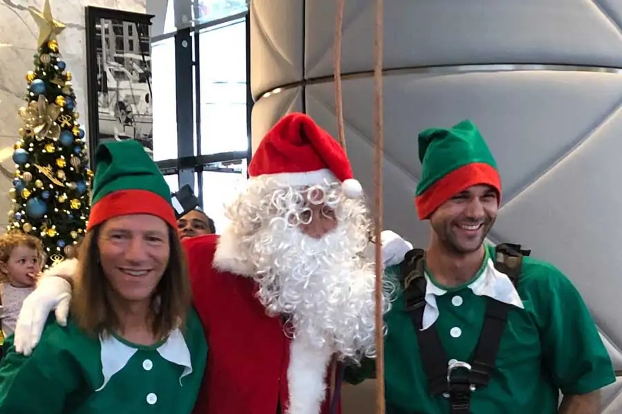 dr jerry schwartz left dressed as an elf at the sofitel sydney darling harbour at christmas