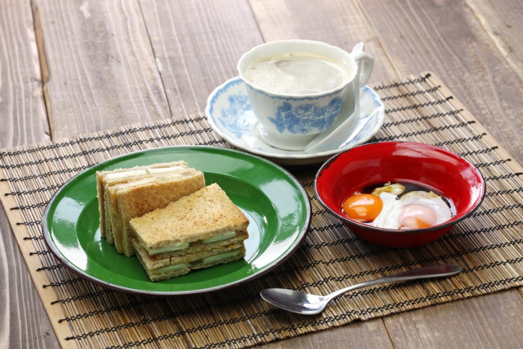 A Singaporean breakfast of toast with kaya jam, eggs and white coffee. Image bonchan Shutterstock