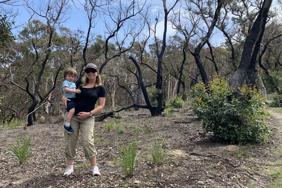 angela and oliver among the charred trees at durras