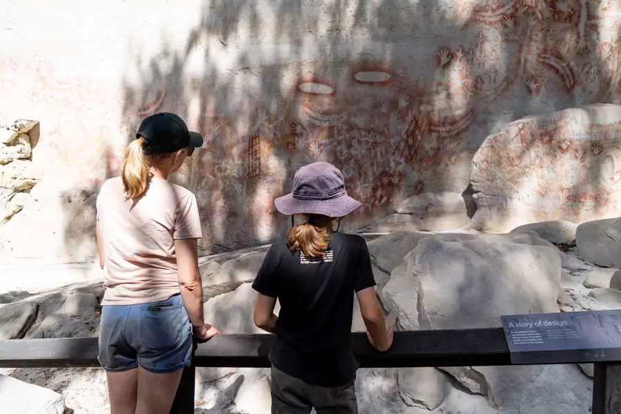 children admiring indigenous rock art at carnarvon gorge in queensland. image tourism and events queensland