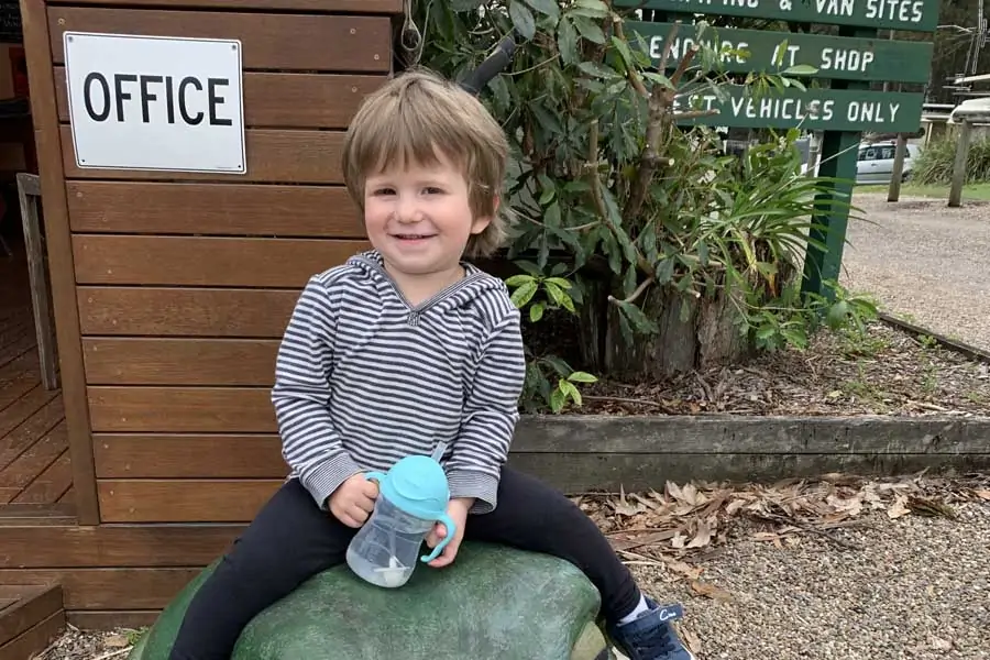 oliver sitting on a frog at durras lake north holiday park