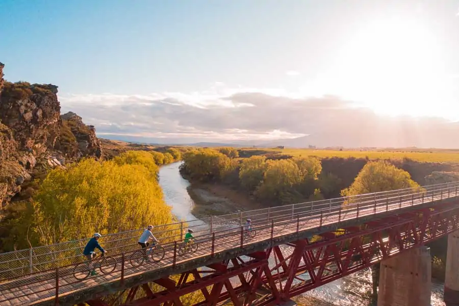 a family cycling the central otago rail trail . image tourism central otago hayden parsons