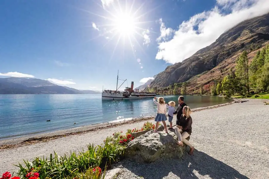 a family waving at the tss earnslaw in queenstown
