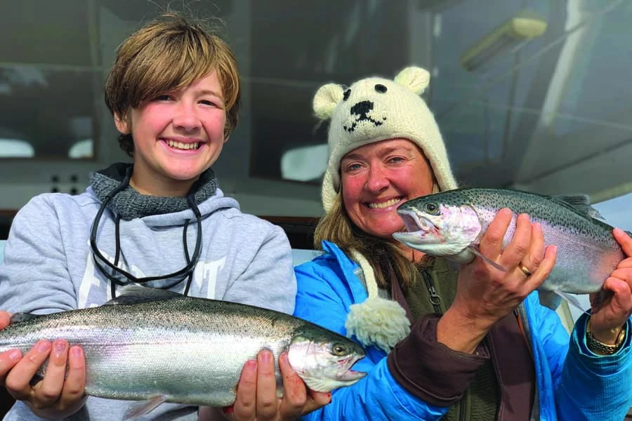 elisabeth and theo showing off their catch at taupo