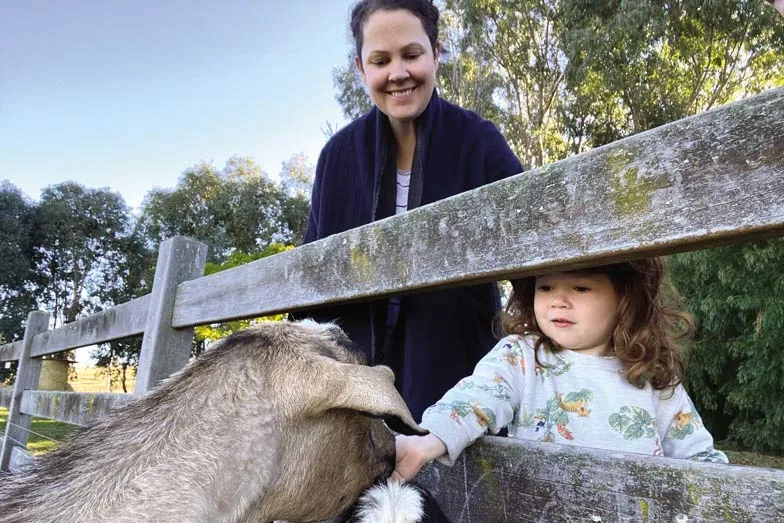 Angus feeding goats at Stone Creek Cottage