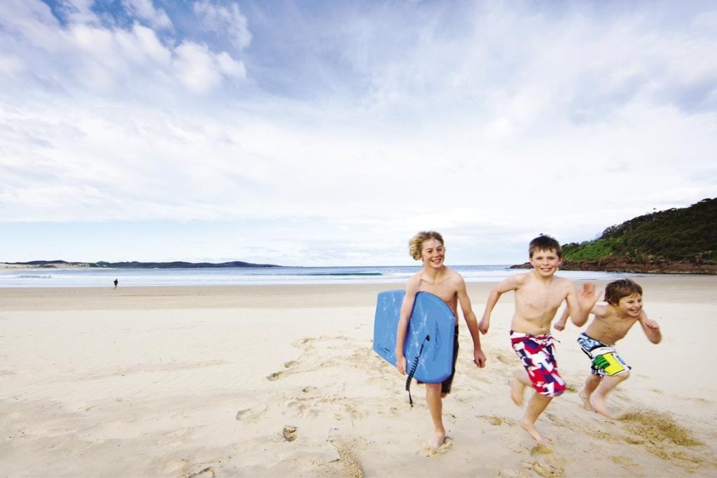 FEATURE Children at One Mile Beach at Forster. Image The Legendary Pacific Coast