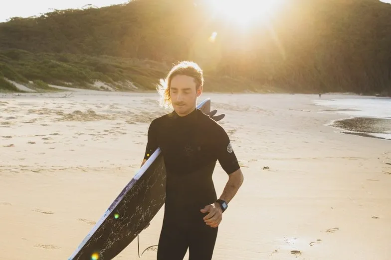 A surfer at Blueys Beach at Pacific Palms. Image Destination NSW