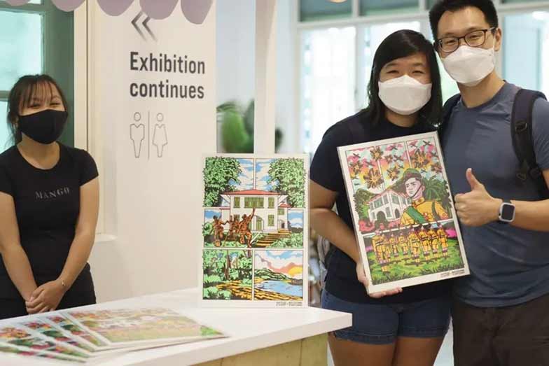 a man and woman posing with a painting that shows Singapore's history