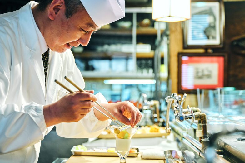 See chefs at work on a KINJO (neighbourhood tour) during a stay at OMO3 Sapporo Susukino by Hoshino Resorts