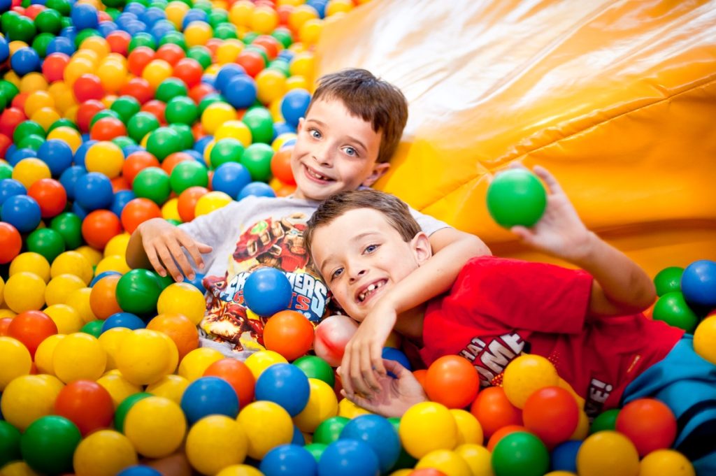 Kids playing in the Neptune's Castle Kids' Club ball pit at Tasman Holiday Parks North Star