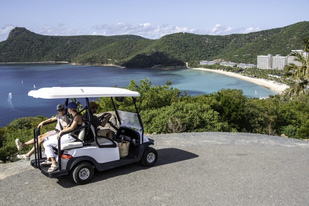 Family on a day trip exploring Hamilton Island in a buggy. Image Tourism and Events Queensland