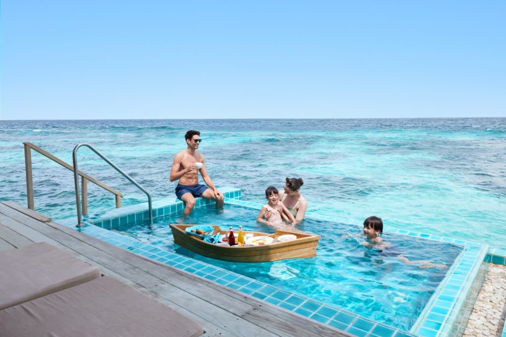 Family enjoying plunge pool at Machchafushi Island Resort and Spa Maldives