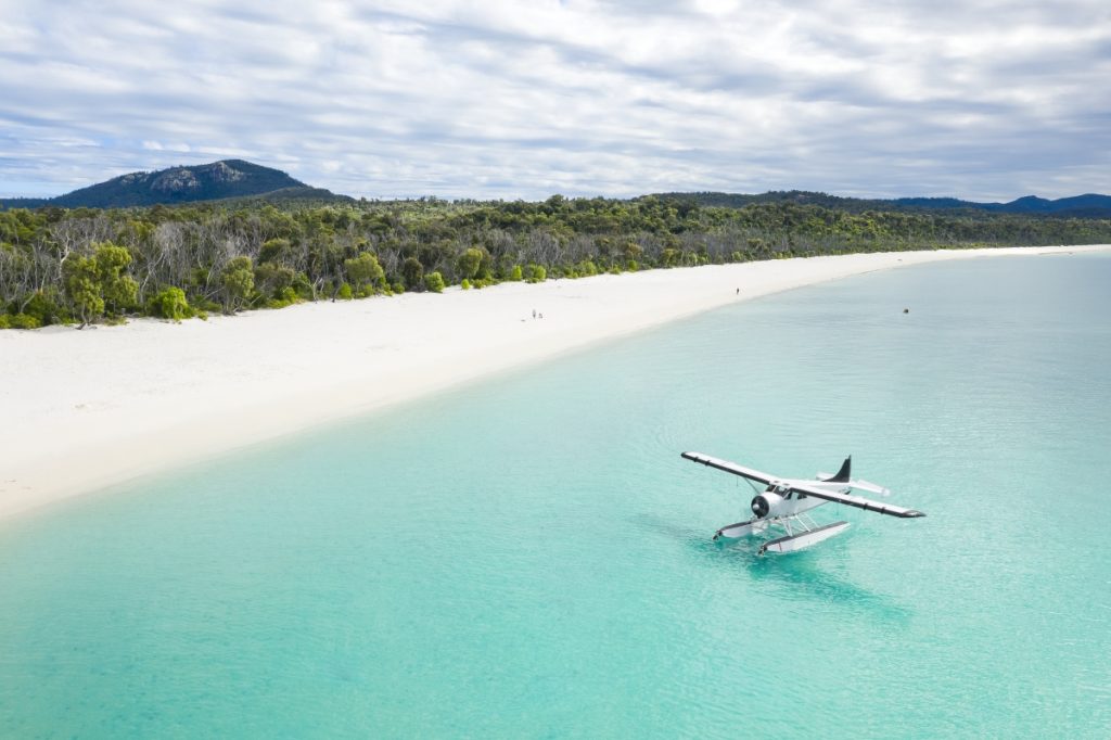 An Air Whitsunday seaplane after landing on the water at Whitehaven Beach. Image Tourism and Events Queensland