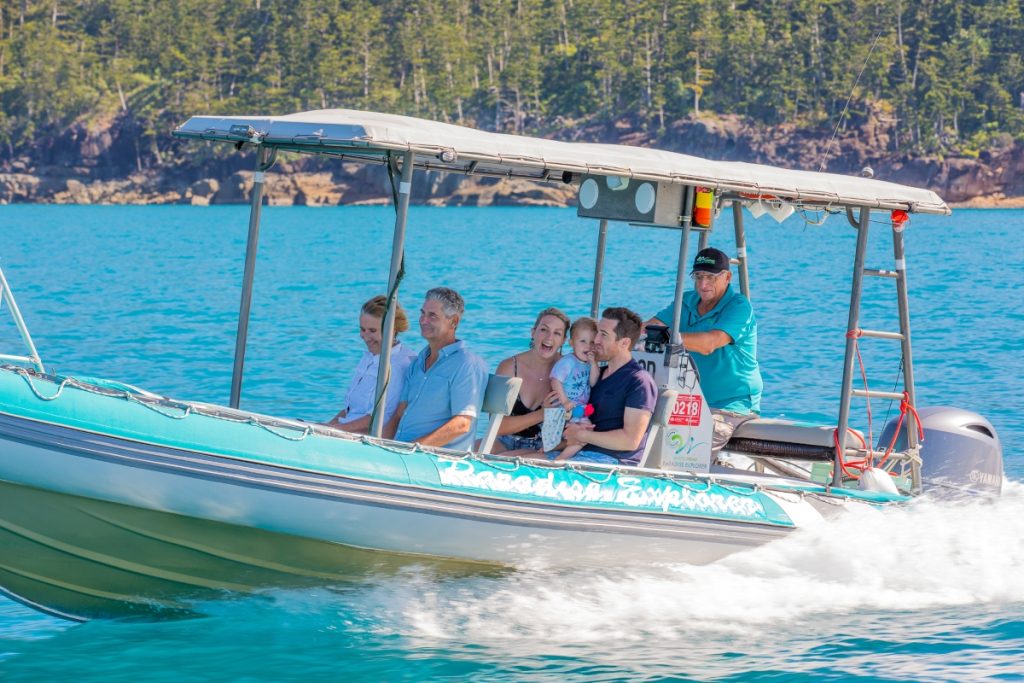 Family with a toddler visiting Whitehaven Beach on a private charter boat. Image Tourism and Events Queensland