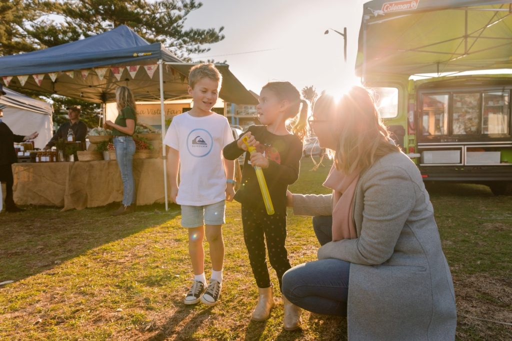 A family at Kiama Farmers' Market. Image Destination NSW