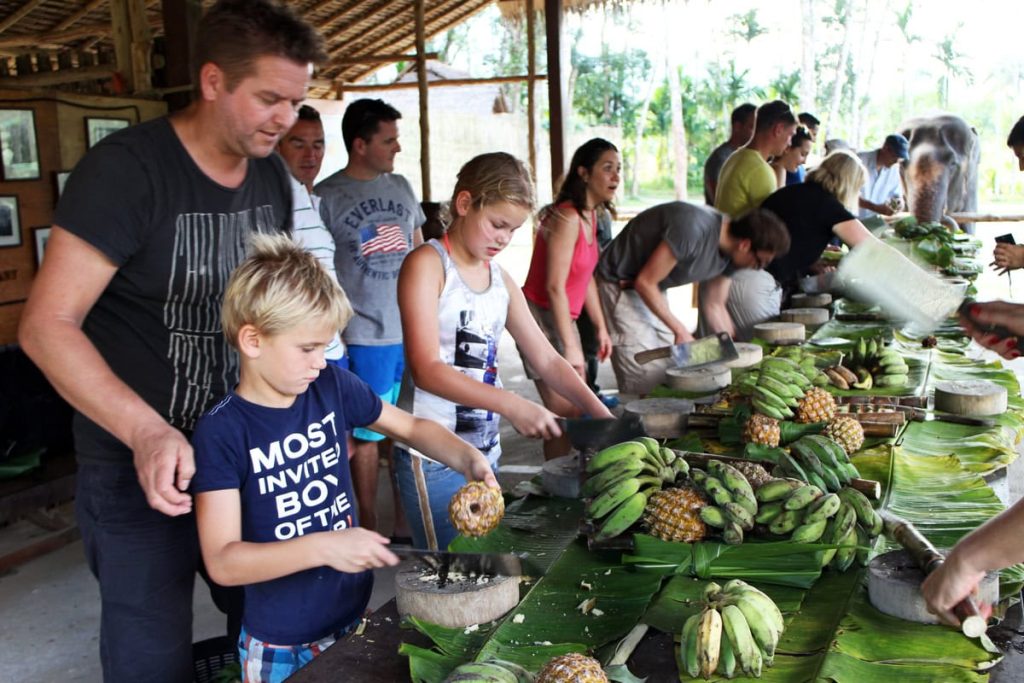 Kids and parents help prepare elephant food at Elephant Hills