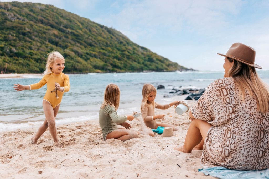 Family playing in the sand at Tallebudgera Creek on the Gold Coast