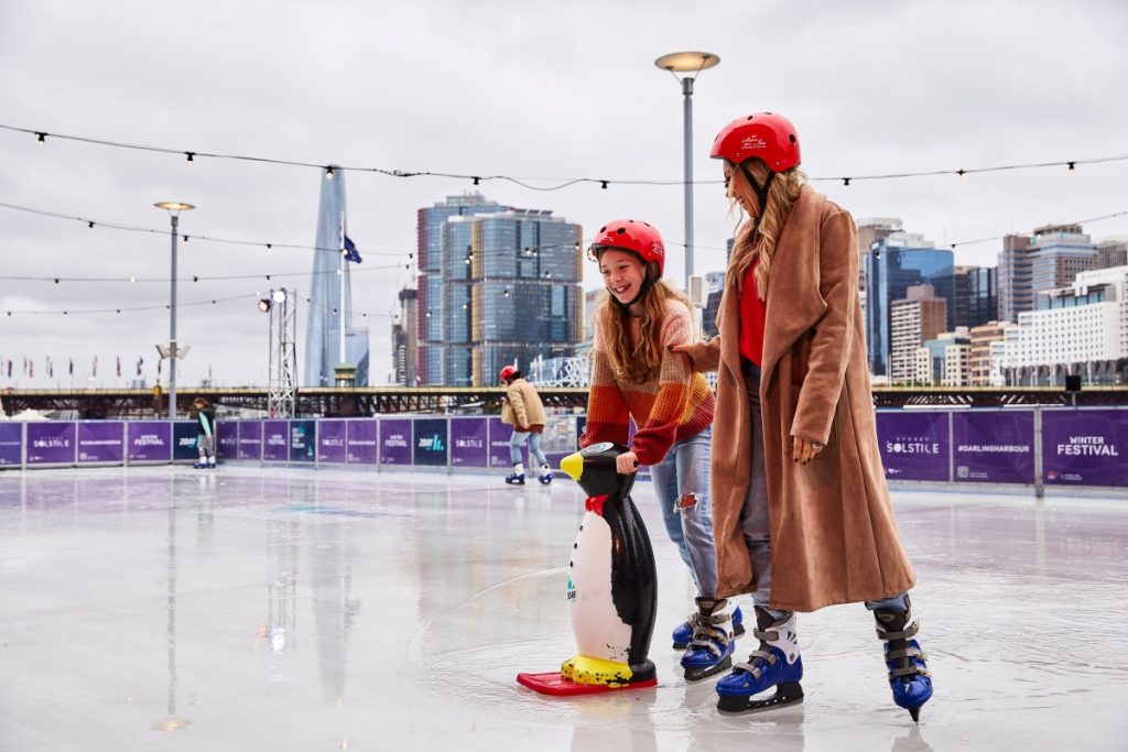 Family ice skating at Darling Harbour, Sydney. Image Destination NSW