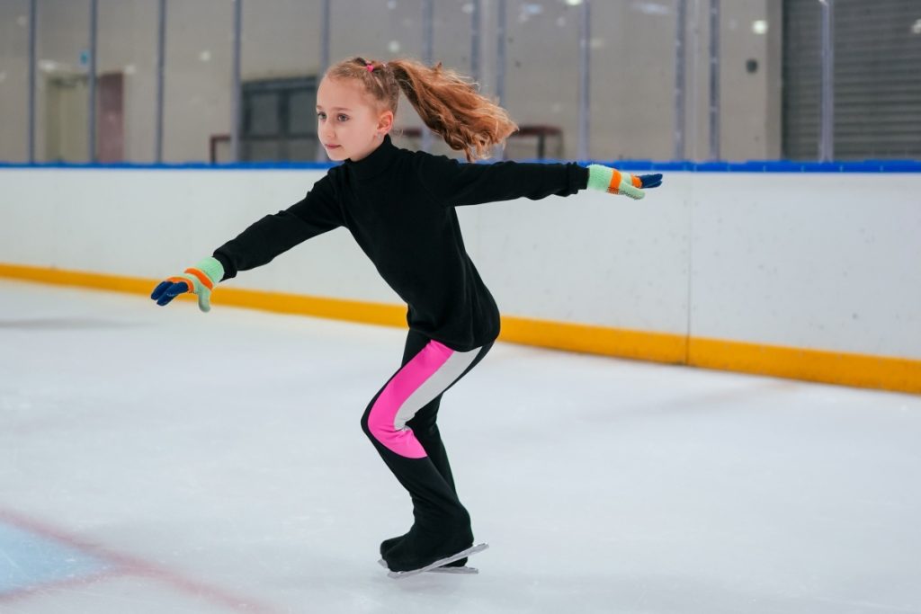 Girl practicing figure skating at ice rink Image Yanus Tug Unsplash