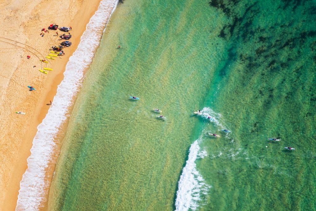 Aerial view of paddleboarders at Toowoon Bay on the Central Coast. Image Destination NSW
